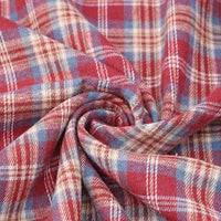 The Cotton Jacquard Plaid Flannel Fabric by the yard from Longan Craft is displayed in a swirl, highlighting its one-sided brushed, soft texture and classic red, blue, and beige checkered pattern—perfect for cozy autumn clothing.