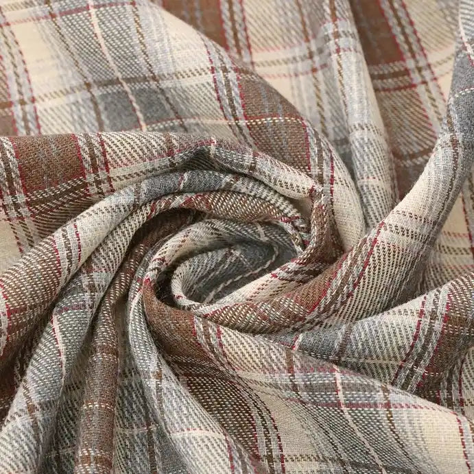 Close-up of Longan Craft’s Cotton Jacquard Plaid Flannel Fabric By The Yard, featuring a cozy brushed texture and intersecting checked lines in soft beige, brown, and gray tones. The flannel material is loosely twisted into a swirl to highlight its woven jacquard pattern and comfortable autumn weight—perfect for clothing projects.