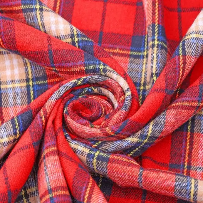A close-up of Longan Craft’s Cotton Jacquard Plaid Flannel Fabric By The Yard showcases its red, yellow, blue, and white one-sided brushed checked design, swirled into a spiral to highlight the cozy texture and intersecting lines of this autumn-ready material for clothing.