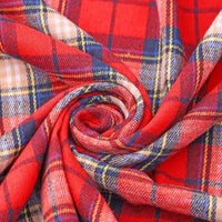 A close-up of Longan Craft’s Cotton Jacquard Plaid Flannel Fabric By The Yard showcases its red, yellow, blue, and white one-sided brushed checked design, swirled into a spiral to highlight the cozy texture and intersecting lines of this autumn-ready material for clothing.
