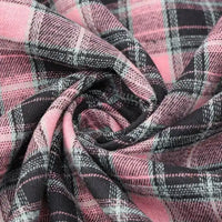Close-up of Longan Craft’s Cotton Jacquard Plaid Flannel Fabric By The Yard in pink, black, and white, twisted into a spiral to showcase the cozy texture and intricate checked pattern of this one-sided brushed autumn flannel material.