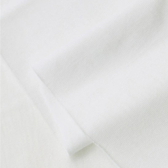 A close-up of Longan Craft’s Cotton Jersey Fabric By The Yard shows its soft, breathable 100% cotton surface with gentle folds and subtle shadows—ideal for making colorful, casual wear.