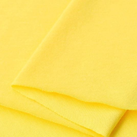 A close-up of Longan Craft Cotton Jersey Fabric by the Yard in bright yellow, highlighting its soft, smooth, and breathable single jersey texture—ideal for making casual wear.