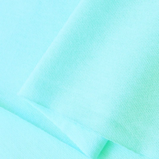 Close-up of Longan Craft Cotton Jersey Fabric By The Yard—colorful, soft single jersey material for casual wear. Fine knit details and subtle shadows highlight its breathable, smooth texture for comfort and quality.