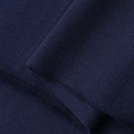 Close-up of Longan Craft’s Cotton Jersey Fabric By The Yard, a neatly folded, navy blue, colorful single jersey material with a smooth texture and breathable qualities—perfect soft jersey fabric for making casual wear.