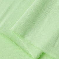 Close-up of Longan Craft Cotton Jersey Fabric By The Yard in light green, showcasing its soft, smooth, thin, lightweight, and breathable single jersey material—ideal for making comfortable casual wear.