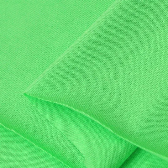 Close-up of Longan Craft's Cotton Jersey Fabric By The Yard—a soft, smooth, and bright green single jersey material with fine knit details, perfect for casual wear.