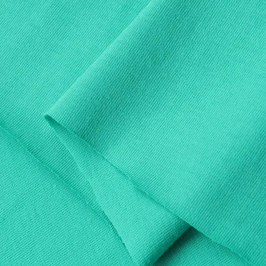 A close-up of Longan Craft's Cotton Jersey Fabric By The Yard reveals its smooth, soft texture and fine knit. This lightweight, vibrant, and breathable colorful single jersey material is ideal for making comfortable casual wear.