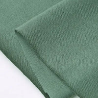 A close-up of Longan Craft’s Cotton Jersey Fabric By The Yard shows its light green, soft, textured cotton surface and fine single jersey weave—ideal for making casual wear.