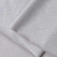 A close-up of Longan Craft's Cotton Jersey Fabric By The Yard, showcasing its light gray color, soft 100% cotton feel, smooth texture, and fine weave—perfect for casual wear and DIY projects.