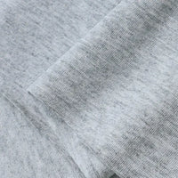 A close-up of Longan Craft's Cotton Jersey Fabric By The Yard showcases its soft, breathable texture and subtle color variations, ideal for casual wear. This colorful single jersey material appears smooth and lightweight with visible folded edges.