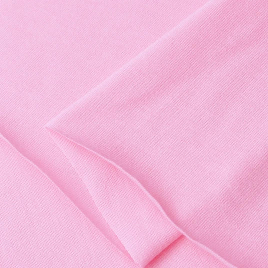 Close-up of Longan Craft Cotton Jersey Fabric By The Yard, a soft, smooth 100% cotton jersey in light pink with clean stitching, perfect for making colorful and comfortable casual wear.