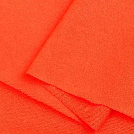 Close-up of Longan Craft’s Cotton Jersey Fabric By The Yard—a vibrant orange, lightweight, breathable single jersey. This soft fabric is neatly layered, showing smooth clean edges—ideal for making casual wear.
