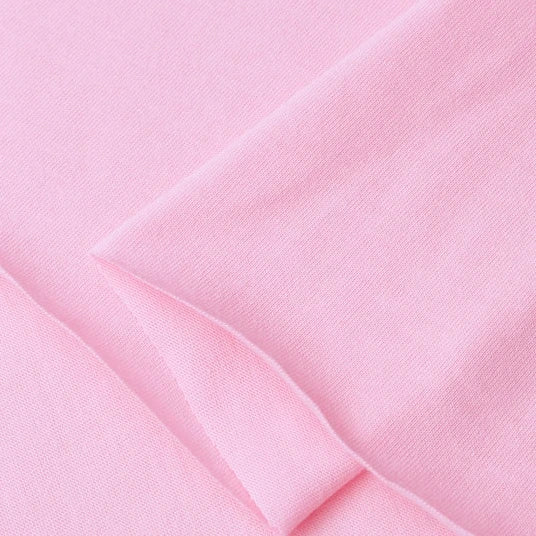 Close-up of Longan Craft Cotton Jersey Fabric By The Yard in light pink, showcasing its soft, smooth 100% cotton texture and gentle folds. This single jersey material is ideal for breathable, comfortable casual wear.