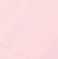 Close-up of Longan Craft's Cotton Jersey Fabric By The Yard, a soft, smooth pale pink colorful single jersey material ideal for making casual wear, shown with a subtle diagonal fold.