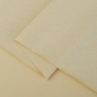 A close-up of Longan Craft's Cotton Jersey Fabric By The Yard, a soft and breathable single jersey material in beige, neatly folded to show its smooth, slightly textured surface—ideal for making casual wear.