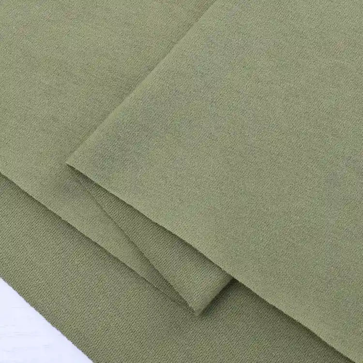 Close-up of neatly folded Longan Craft Cotton Jersey Fabric By The Yard in olive green, featuring a visible woven texture and soft, breathable finish—perfect single jersey material for making casual wear.