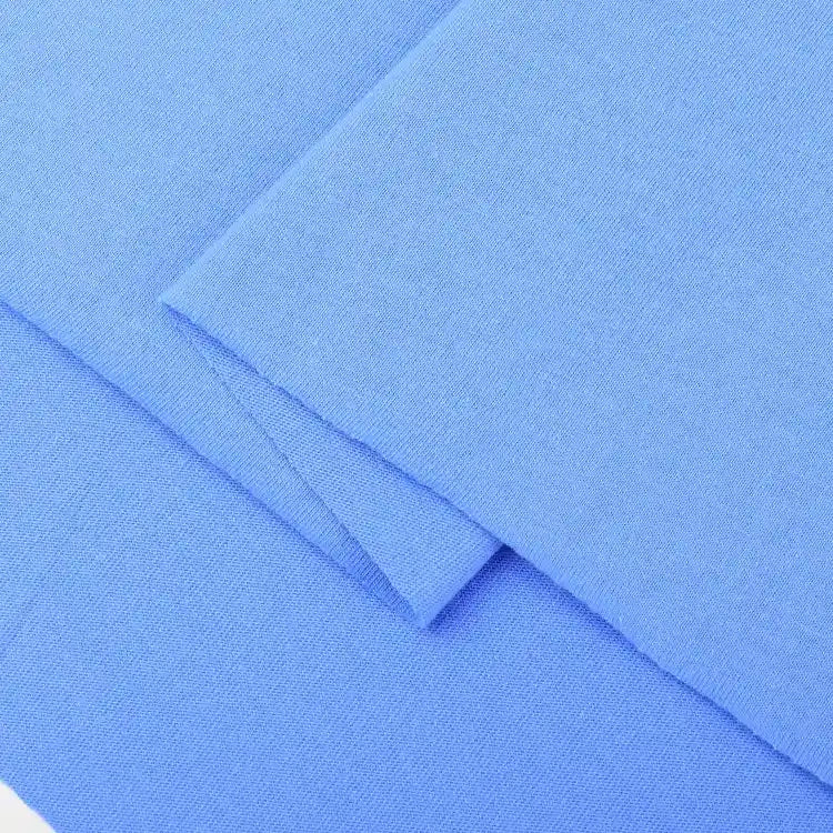 Close-up of Longan Craft Cotton Jersey Fabric by the yard, colorful single jersey material with a soft, smooth texture—ideal for making casual wear. Light blue fabric is neatly folded on a flat surface.