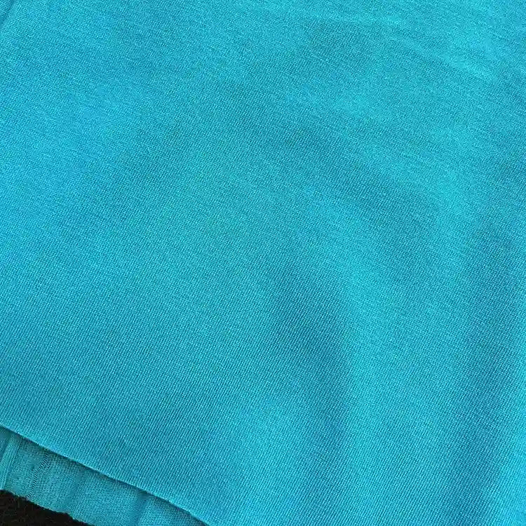 A close-up of Longan Craft’s Cotton Jersey Fabric By The Yard in turquoise blue, showcasing its soft texture, fine weave pattern, and breathable quality—ideal colorful single jersey material for casual wear.