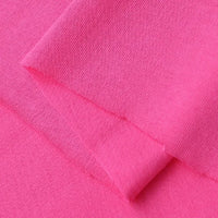 Close-up of Longan Craft's Cotton Jersey Fabric By The Yard in bright pink, folded to highlight its fine weave, soft texture, and breathable quality—ideal single jersey material for making casual wear.