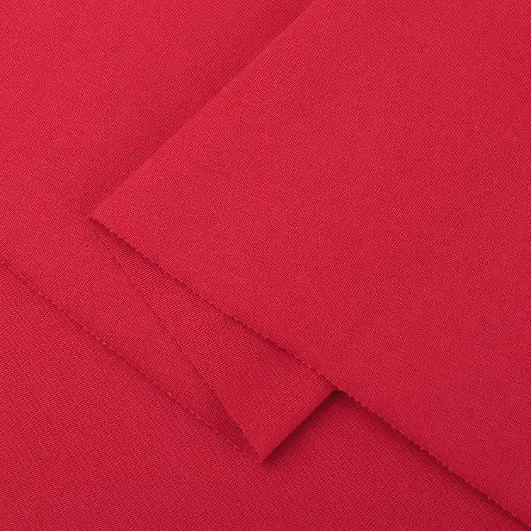 Close-up of Longan Craft Cotton Jersey Fabric By The Yard in bright red. This colorful single jersey material features a smooth, soft texture with a slightly visible weave, neatly cut edges, and is ideal for making casual wear.