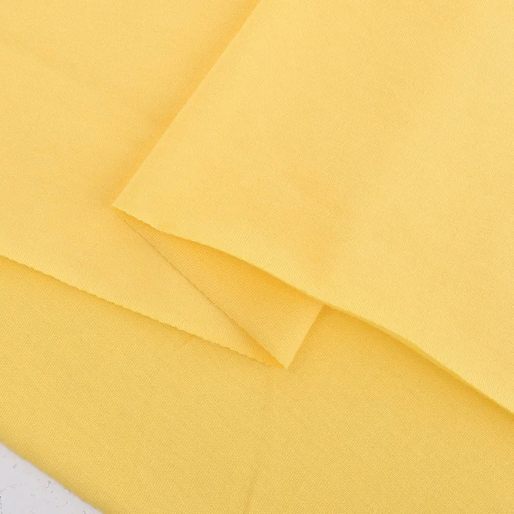 Longan Craft’s Cotton Jersey Fabric By The Yard is a colorful, soft single jersey material for casual wear. Lightweight and breathable, the fabric is neatly folded to showcase its smooth texture and inviting appearance.