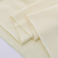 A close-up of Longan Craft's Cotton Jersey Fabric By The Yard, a colorful, soft single jersey material with a smooth, slightly textured surface, neatly layered and overlapping on a white background—ideal for casual wear.