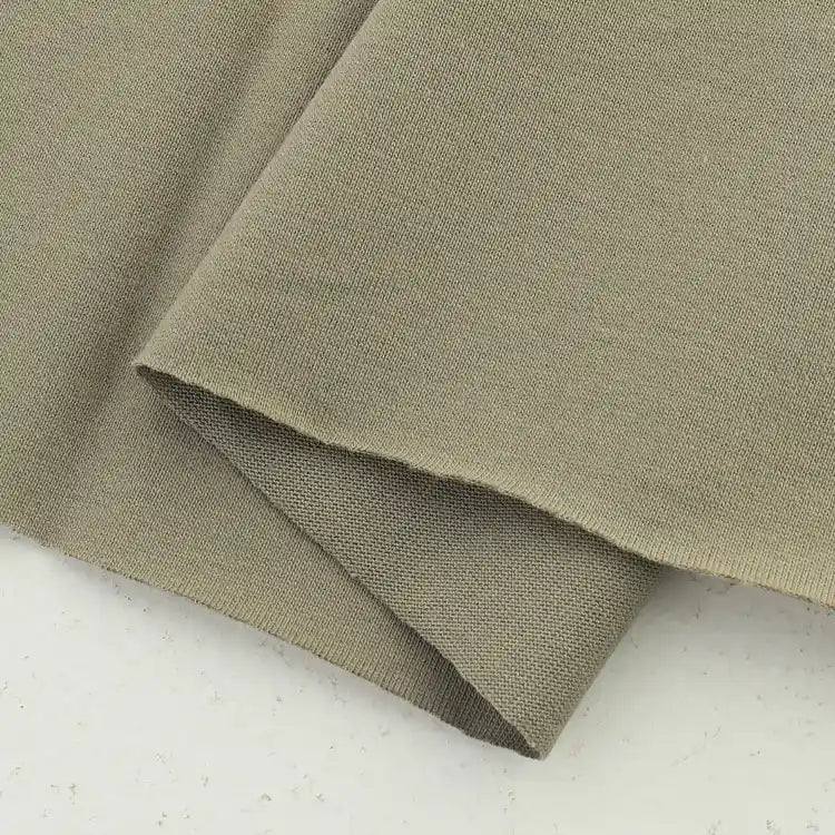 A close-up of Longan Craft Cotton Jersey Fabric By The Yard, a soft, colorful single jersey material for casual wear, shown neatly folded on a white speckled background.