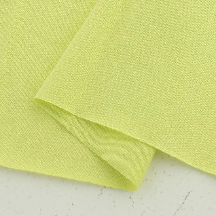 A close-up of Longan Craft’s Cotton Jersey Fabric By The Yard, a soft, colorful single jersey cotton material with a smooth texture, folded at an angle on a light surface—ideal for making casual wear.