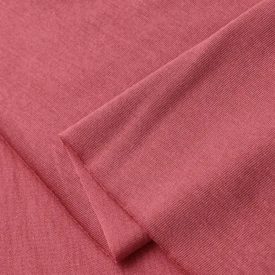 A close-up of two overlapping pieces of Longan Craft Cotton Jersey Fabric By The Yard, featuring soft, rose-pink single jersey material with a smooth finish and neat edges, perfect for breathable and comfortable casual wear.