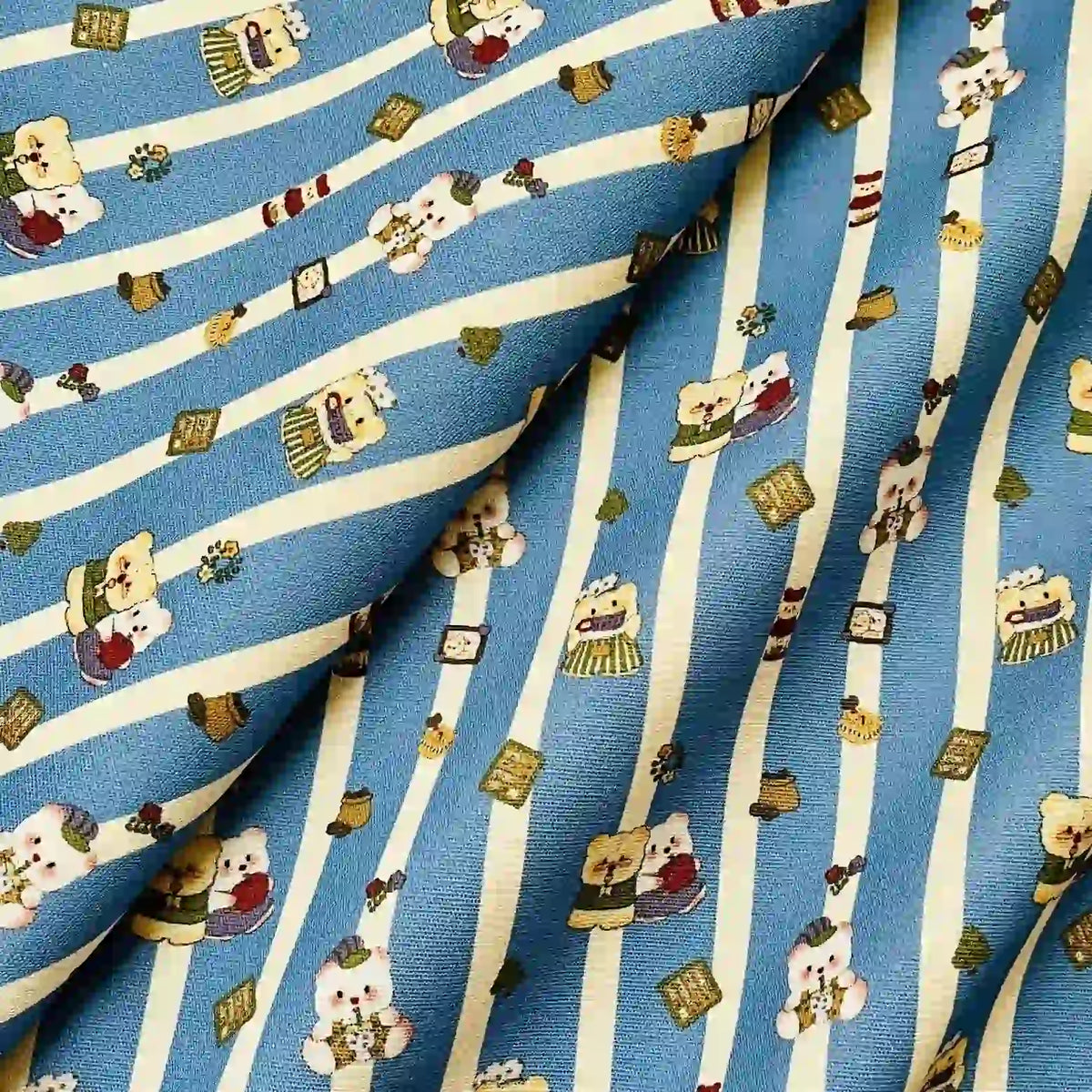Cute Dog Print Striped Canvas Fabric By The Yard featuring a pattern of teddy bears and small icons on a blue and white striped background.