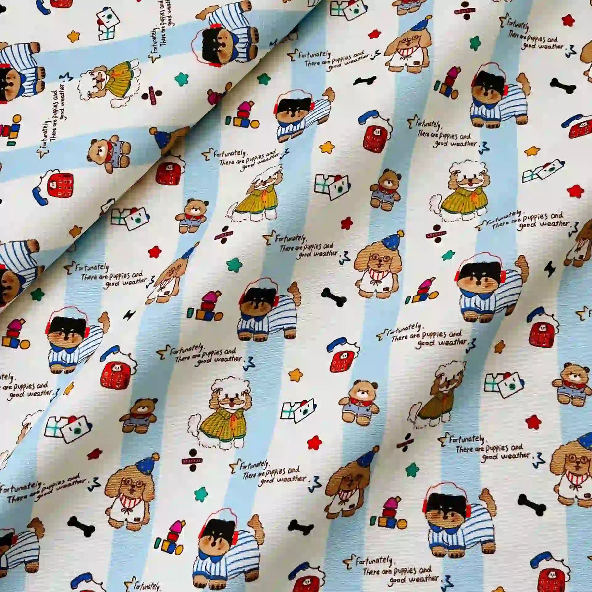 Cute Dog Print Striped Canvas Fabric By The Yard in light blue and white cotton, featuring a repeating pattern of cartoon dogs, bears, and the text, Fortunately, there are puppies and good weather.