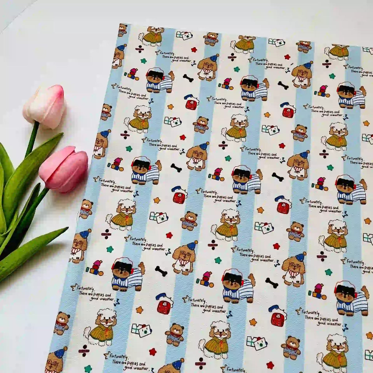 Cute Dog Print Striped Canvas Fabric By The Yard featuring cartoon dogs and bears in hats, small icons, and the text, Fortunately, there are puppies and good weather, on a patterned canvas with striped accents.