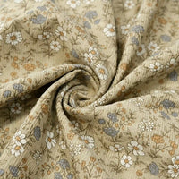 Longan Craft’s Daisy Print 16 Wale Corduroy Fabric by the yard is a fine wale, 100% cotton beige corduroy material featuring a delicate print of small white, blue, and yellow flowers—arranged here in a swirl shape to showcase its soft texture and charming floral design—perfect for fall DIY projects.