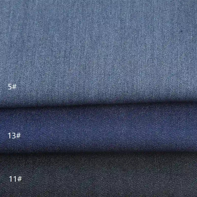 Three stacked swatches of Longan Craft's Denim Color Twill Viscose Fabric By The Yard in shades 5#, 13#, and 11# display varied blue hues and textures, ideal stretch viscose material for jackets, from the Chic Viscose Textile collection.