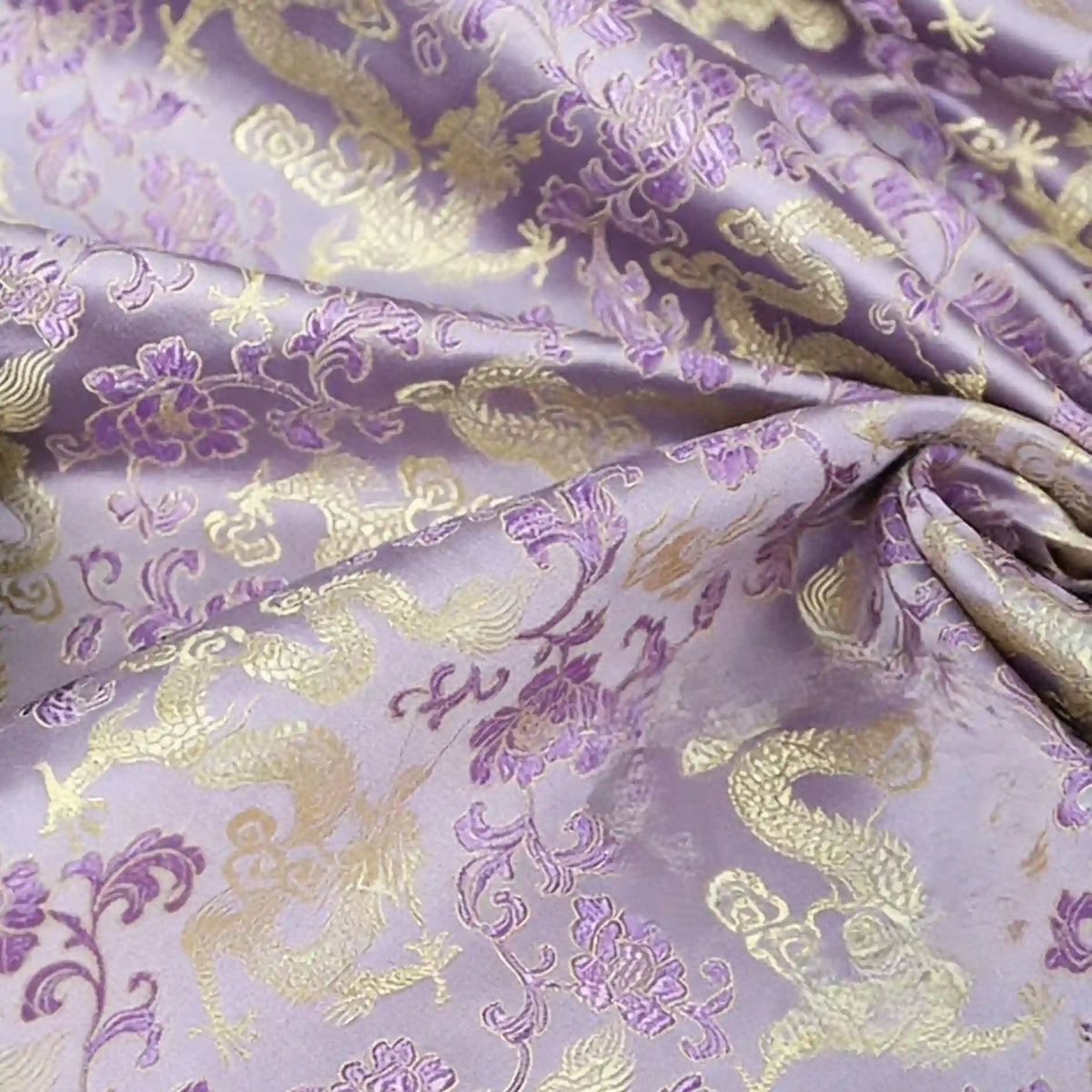 Longan Craft’s Dragon Pattern Brocade Fabric by the yard features multicolor chinoiserie designs with woven dragons and flowers for a luxurious shine. This vintage brocade material is slightly wrinkled, smooth, and adds ornate beauty to any project.