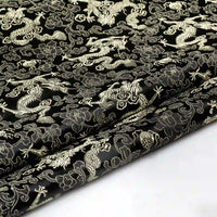 Longan Craft’s Dragon Pattern Brocade Fabric by the yard features intricate multicolor chinoiserie dragon, cloud, and floral motifs. This vintage brocade cloth material exudes an ornate East Asian style, with rich details visible along its slightly folded edge.