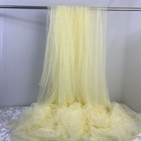 Elegant Pearl Embellished Tulle Fabric by the yard from Longan Craft drapes gracefully with sheer, pale yellow pearl accents—ideal for bridal gowns or evening dresses. This lightweight, solid color tulle is perfect for wedding fashion.