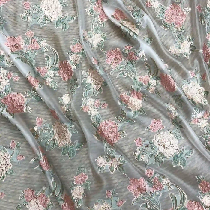 Longan Craft's Embossed Rose Organza Fabric By The Yard features gold floral jacquard embroidery. This sheer, lightweight organza is perfect for camisole tops and drapes beautifully, creating soft folds and highlighting its elegant texture.