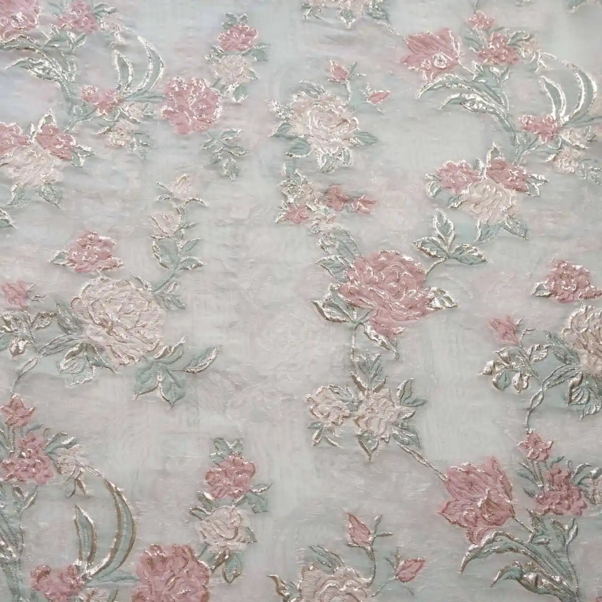 Longan Craft Embossed Rose Organza Fabric by the yard features gold floral jacquard roses and pale green leaves on sheer, lightweight organza—perfect for camisole tops with a delicate, elegant touch.