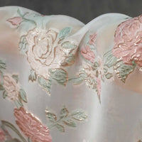 A close-up of Longan Craft's Embossed Rose Organza Fabric By The Yard, a sheer lightweight gold floral jacquard organza perfect for camisole tops, showcasing its elegant texture and intricate design.