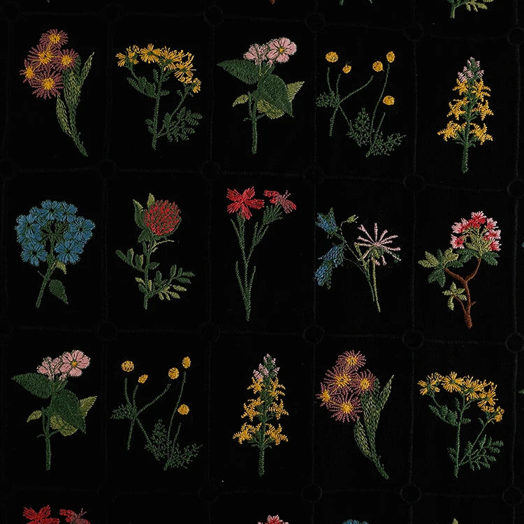Longon Craft's Plant Floral Embroidered Cotton Fabric By The Yard features a grid of colorful wildflowers stitched on soft, breathable cotton fabric with a bold black background—perfect for apparel and crafts.