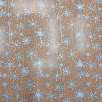 A close-up of Longan Craft’s Embroidered Sequin Tulle Fabric by the yard shows blue snowflake embroidery on a light brown net, ideal for DIY wedding dresses and children's apparel. The detailed sequin outlines evoke embellished tulle designs.