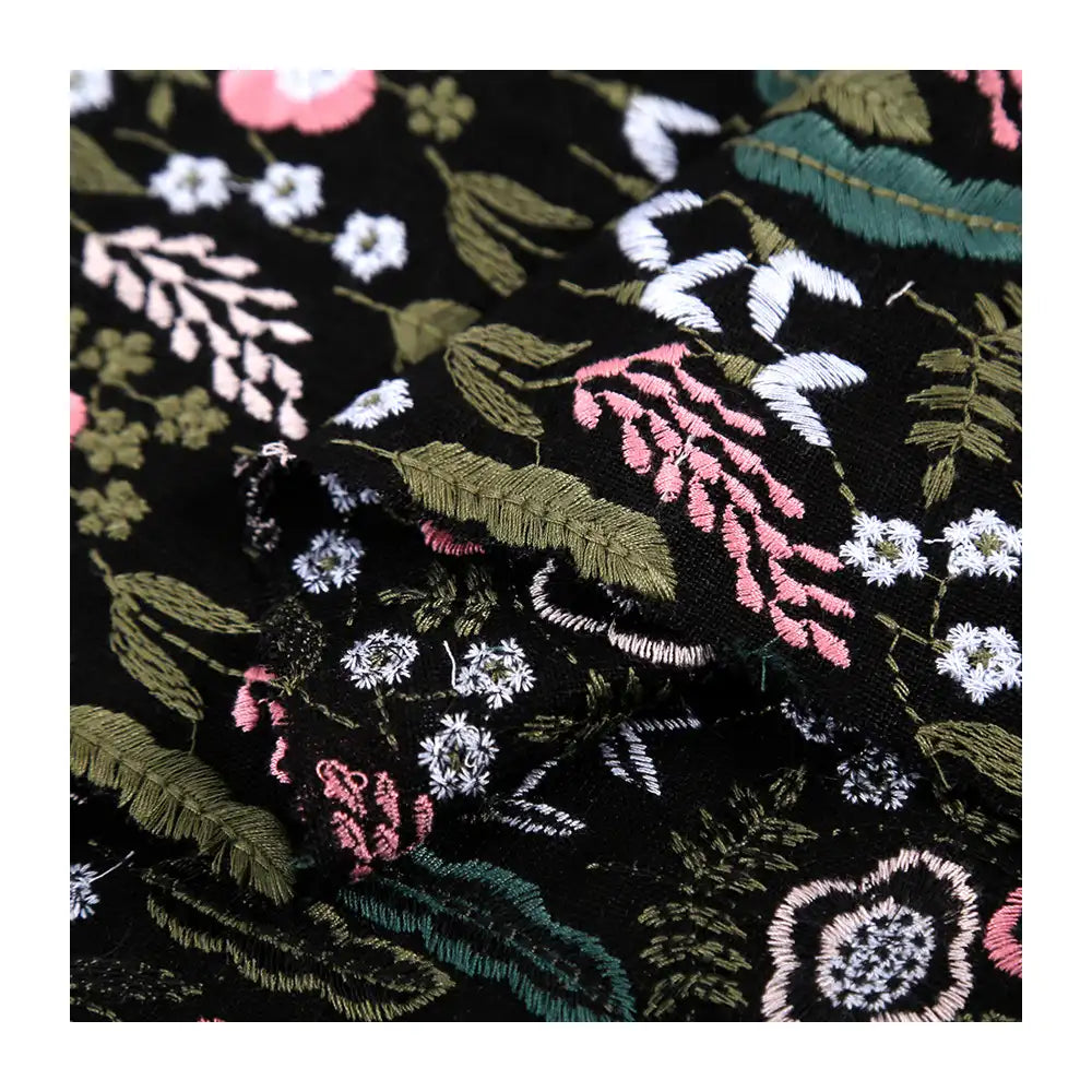 Longon Craft's Floral Cotton Linen Embroidered Fabric By the Yard features detailed green, pink, white, and blue floral embroidery on black or white cotton linen—perfect for dressmaking and creative fabric projects.