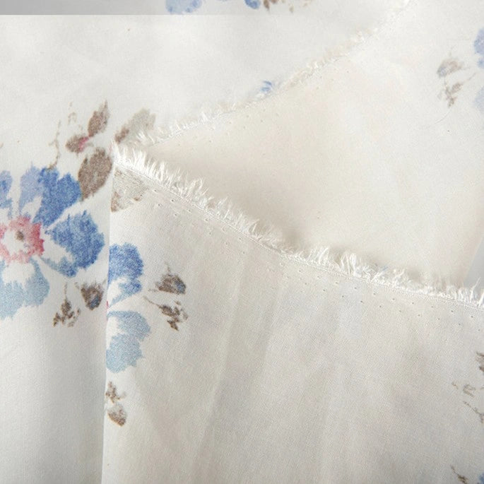 Close-up of Longan Craft Floral Digital Print Voile Fabric by the yard, featuring a sheer and breathable lightweight cotton voile with blue, pink, and brown flower patterns; the textured weave is clearly visible—ideal for tops.