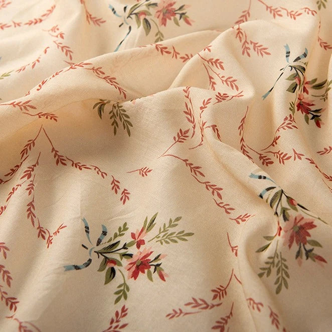 Longan Craft’s Floral Digital Print Voile Fabric by the yard features a cream base with a delicate multicolor floral pattern and branch-like details. Lightweight, breathable cotton voile—perfect for tops and summer apparel.