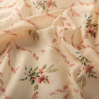Longan Craft’s Floral Digital Print Voile Fabric by the yard features a cream base with a delicate multicolor floral pattern and branch-like details. Lightweight, breathable cotton voile—perfect for tops and summer apparel.