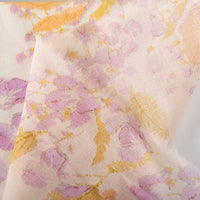 A close-up of Longan Craft’s Floral Digital Print Voile Fabric by the yard, a lightweight, breathable cotton voile with a soft pastel pink, purple, and yellow floral pattern and delicate unfinished edges—ideal for tops.
