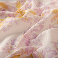 A close-up of Longan Craft's Floral Digital Print Voile Fabric by the Yard—a lightweight, breathable cotton voile with a pastel floral pattern in pink, purple, and yellow on a light background, ideal for tops.