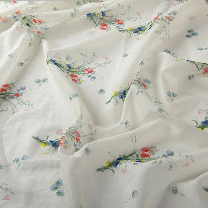 Longan Craft Floral Digital Print Voile Fabric By The Yard features a delicate floral pattern with blue, red, and yellow flowers on lightweight, breathable cotton voile—perfect for tops.